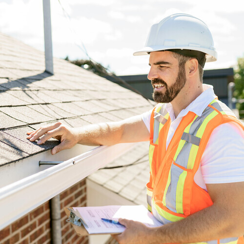 worker providing a roof inspection