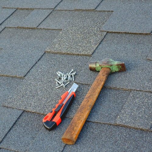 tools on a shingle roof